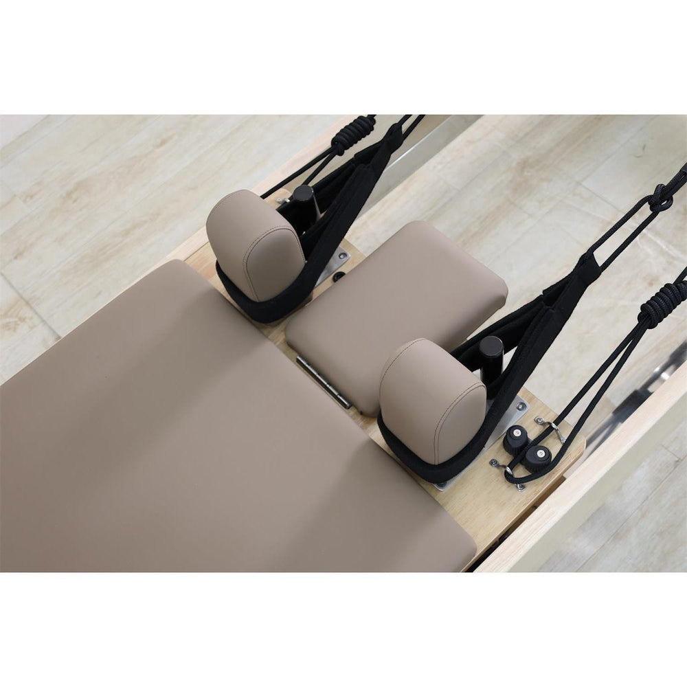 Gym Superstore professional wooden Pilates reformer carriage with beige upholstered padding and black rope handles