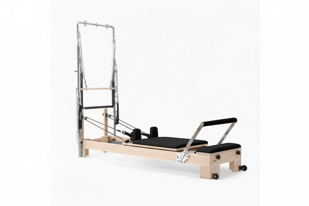 Pilates reformer tower in oak with black seats on a white background - Premium Pilates Reformer | Gym Superstore