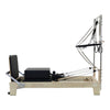 Gym Superstore professional wooden Pilates reformer with integrated tower attachment and black padded carriage