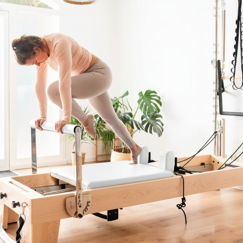 Women working out on an oak pilates reformer machine in a home gym setting